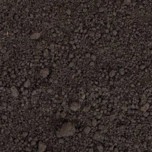 Close-up image of dark, textured soil with various sized clumps. No people, landmarks, or buildings are visible in the photograph.