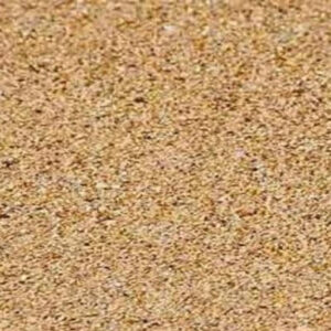 A close-up view of a sand texture, featuring a mix of small, rough grains in various shades of tan and brown, filling the frame.